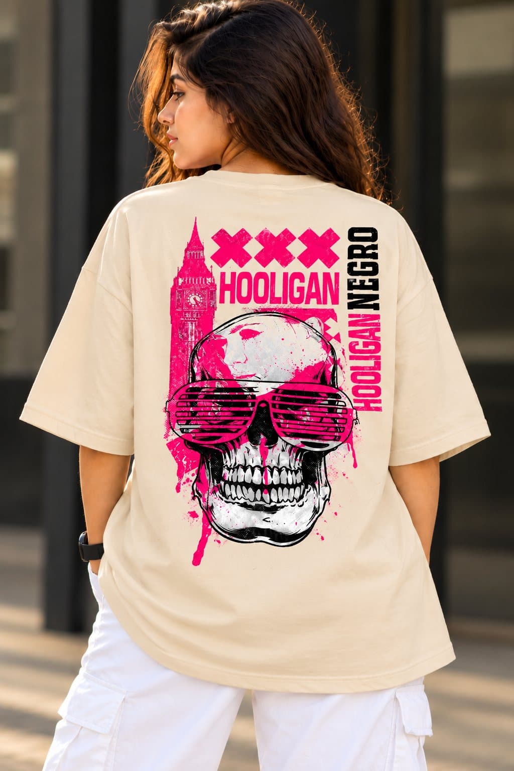 Beige oversized t-shirt with a detailed neon-pink skull printed on the back