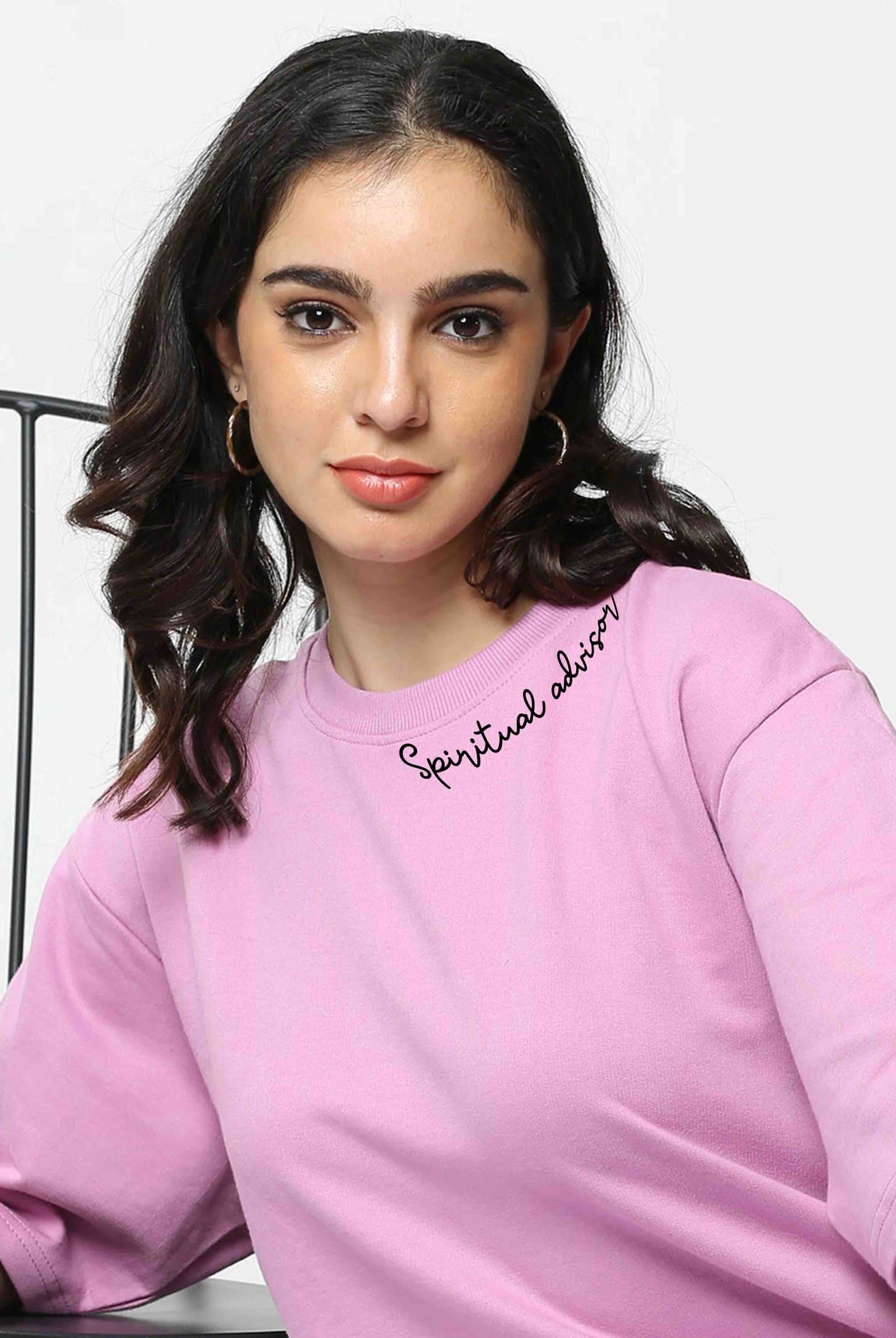 Woman in a soft pink cotton t-shirt with 'Spiritual advisor' written along the neckline